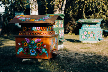 Beehives painted with floral decorative motifs, classic polish art, in zalipie village, Poland