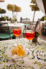 Italian traditional food and aperitif in the northern Italy, Lombardy, Milan. Two glasses of an alcoholic cocktail 