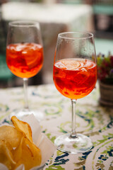 Italian traditional food and aperitif in the northern Italy, Lombardy, Milan. Two glasses of an alcoholic cocktail 