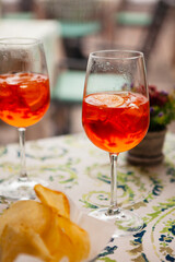 Italian traditional food and aperitif in the northern Italy, Lombardy, Milan. Two glasses of an alcoholic cocktail 