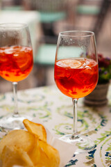 Italian traditional food and aperitif in the northern Italy, Lombardy, Milan. Two glasses of an alcoholic cocktail 