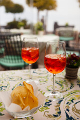Italian traditional food and aperitif in the northern Italy, Lombardy, Milan. Two glasses of an alcoholic cocktail 