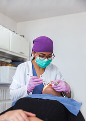Dentist with glasses and mask during the patient's treatment in a dental office