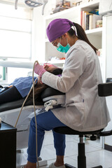 Dentist with glasses and mask during the patient's treatment in a dental office
