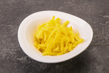 Shredded yellow cheese in the bowl