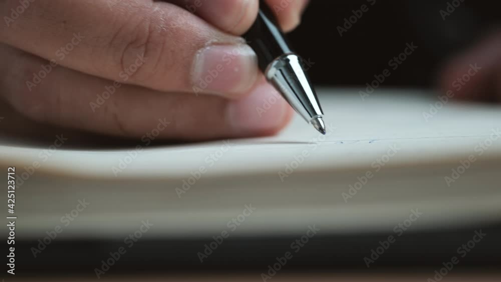 Poster Close up view of a handwriting down on a white blank notebook