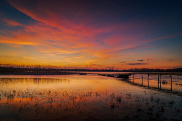 beautiful, fabulous sunset over the frozen lake and the pier - Lake Rotcze