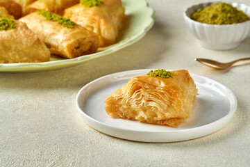 Sweets arabic dessert baklava, , kunafa, kadayif with pistachio nuts and cheese . Closeup