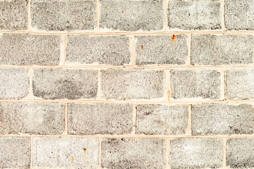 Texture of a brick wall with cracks and scratches which can be used as a background