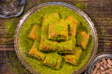 Obraz na płótnie Canvas Traditional Turkish Ramadan dessert - baklava with pistachios (Turkish: fistikli baklava). Eid mubarak. Ramazan bayrami. Ramadan kareem.