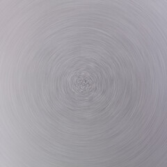 Circle of brushed aluminum metal in defocused blur motion abstract background