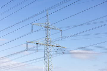 power pylon with power wires, blue sky as background, view from below