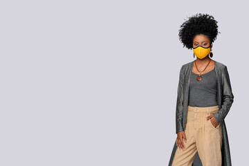 black teenager wearing facial protection mask against covid 19 isolated on gray background 