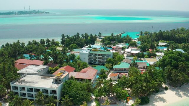 Drone view of a tropical island with a hotel and residential property. Thinadhoo (Vaavu Atoll), Maldives