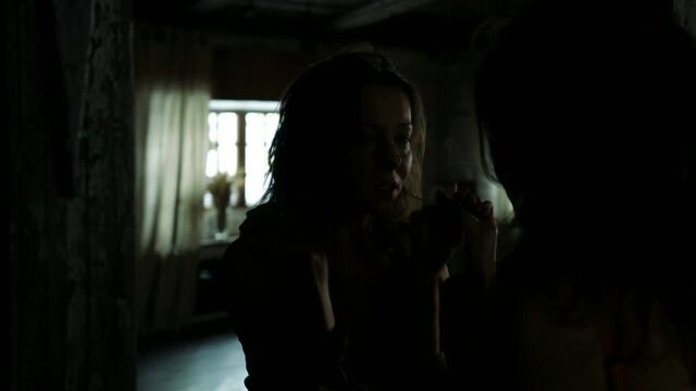 silhouette and reflection in wall mirror of adult excited woman in dark room, mysterious portrait of lady