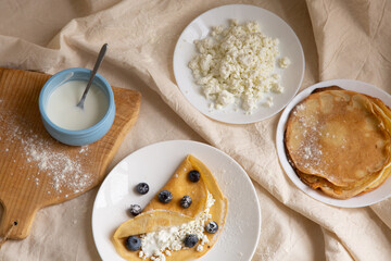 beautiful breakfast with pancakes and cottage cheese and berries