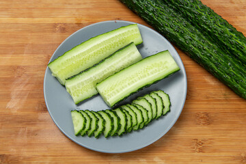 sliced of fresh green cucumber on plate