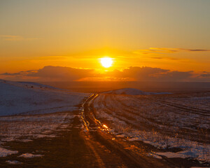 Fototapeta na wymiar Sunset view of countryside road in spring, Shengeldy, Kazakhstan