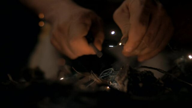 An ancient man lights a fire in a cave. Slow motion