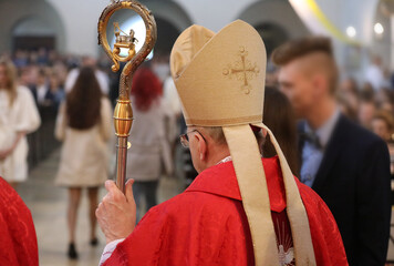 The bishop provides the Sacrament of Confirmation  - obrazy, fototapety, plakaty