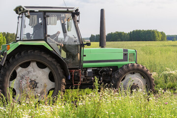 tractor moves through the meadow