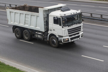 Dump truck driving on a multi-lane road