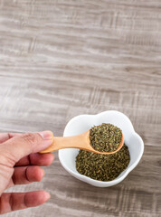 Close up of wooden spoon with basil.