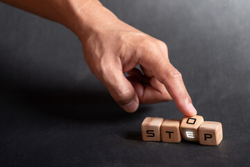 Hand holding dice with text for illustration of "Step and Stop" words