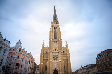 Fototapeta na wymiar The Name of Mary Church, also known as Novi Sad catholic cathedral or crkva imena marijinog during a cloudy spring afternoon. This cathedral is one of the most important landmarks of Novi Sad, Serbia