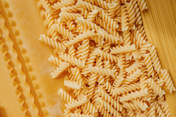 Types of pasta on full frame. shapes of handmade pasta. real life atmosphere. from durum wheat homemade pasta . Mediterranean dishes. selective focus