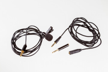 Small lavalier microphone or lapel mic with clip, adapter and extension cable