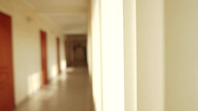 empty hotel corridor into the coronavirus a pandemic. bankruptcy of hostel hotel in coronavirus no people losses. empty corridor in hotel hallway doors to rooms light from window view inside hostel