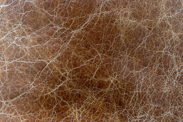 Weathered brown leather material from a indoor, house, home couch with elegant decor style and close up shot, photo of furniture. 
