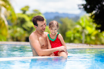 Fototapeta na wymiar Father, child at swimming pool. Dad and kid swim.