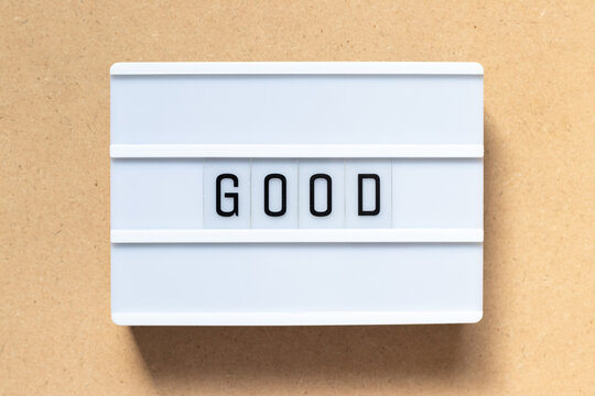 White lightbox with word good on wood background