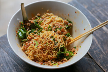 Dry noodles with minced pork in a bowl of noodles look delicious. Dry noodles with minced pork The Food of Thailand has a spicy flavor, Tom Yum seasoning.