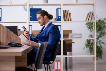 Young male employee working in the office