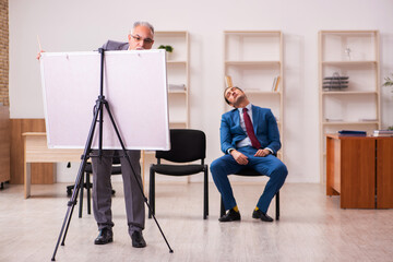 Two male employees in business meeting concept