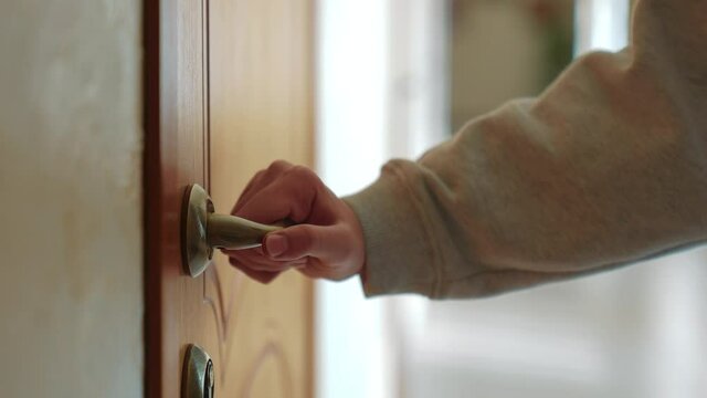 hand opens knob the door a in the hotel house. business service motel travel concept. tourist hand opens the door to the hotel room. door knob opens apartments close-up