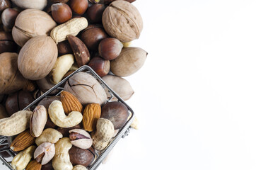 A cart full of different nuts and a mountain of nuts on a white background assorted nuts top view of kopi space