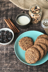 Healthy oat and flaxseed cookies in dark wood with your healthy ingredients for breakfast or snacks