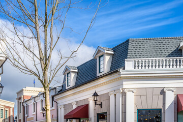 A perfect neighborhood. Houses in suburb at Summer in the north America. Top of a luxury house with nice window over dramatic pink clouds in the sky.