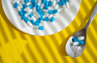 Tablets on a plate. Medicine for the patient on a spoon. Tablet on a spoon.