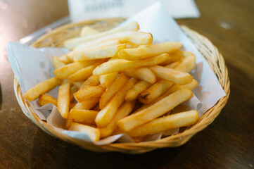 French fries on plates and blotting papers.soft light with Vintage tone.