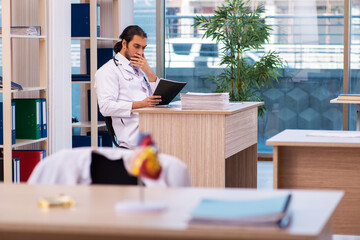 Young male doctor cardiologist working in the clinic