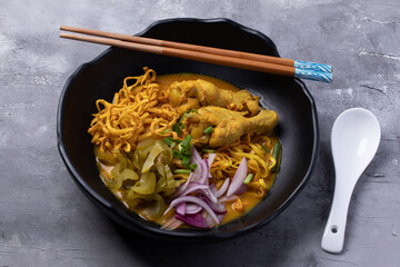 Khao Soi Recipe, Northern Style Curried Noodle Soup with Chicken in a black plate.