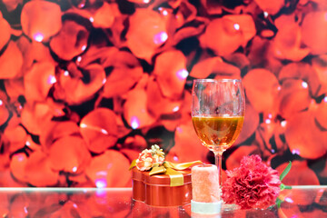 red wine, carnation flower, candle, gift box with colourful rosy background. Concept of romantic mother father valentine wedding day