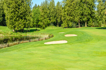 Golf course with gorgeous green and sand bunker