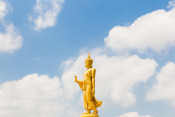 The standing buddha with blue sky and cloud,Copy space