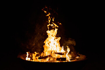 wood fire in a big cement bowl at the beach